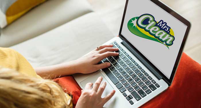 Woman Looking on Laptop for Move Out House Cleaning Services.